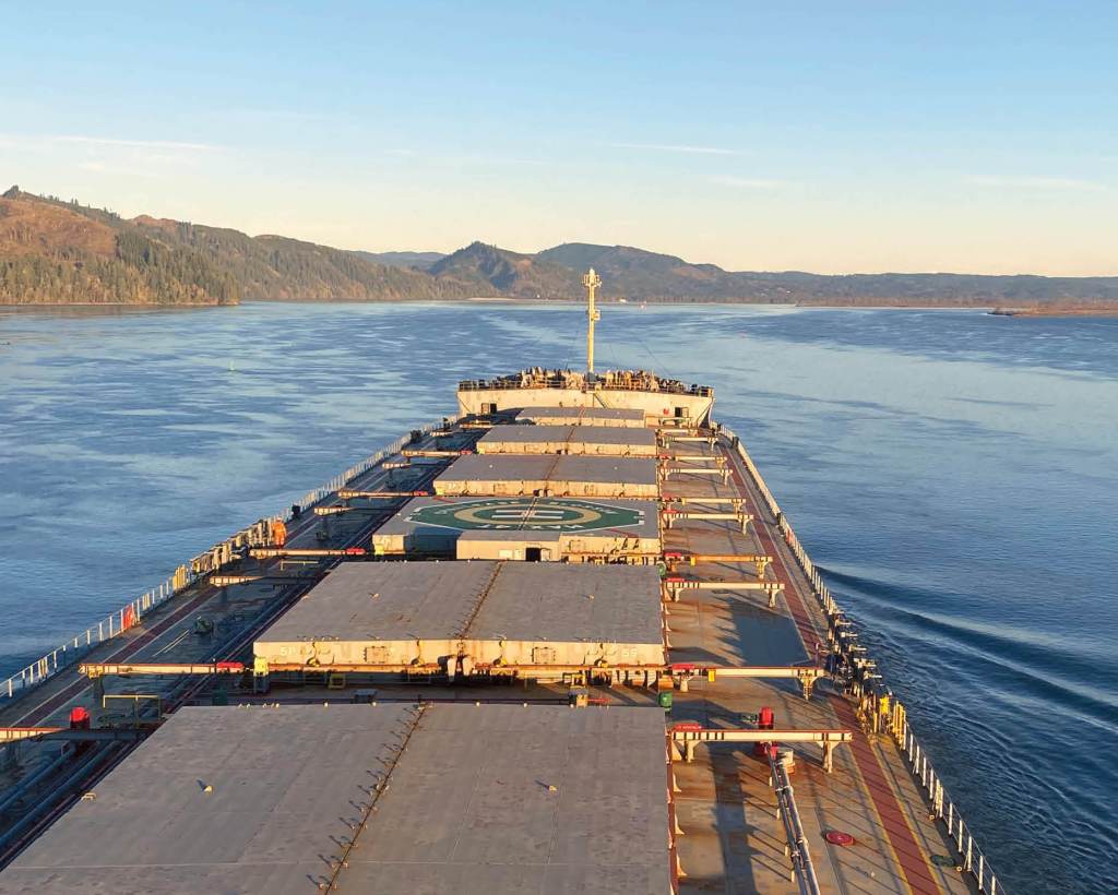 Looking out on the prow of a Panamax ship with river behind